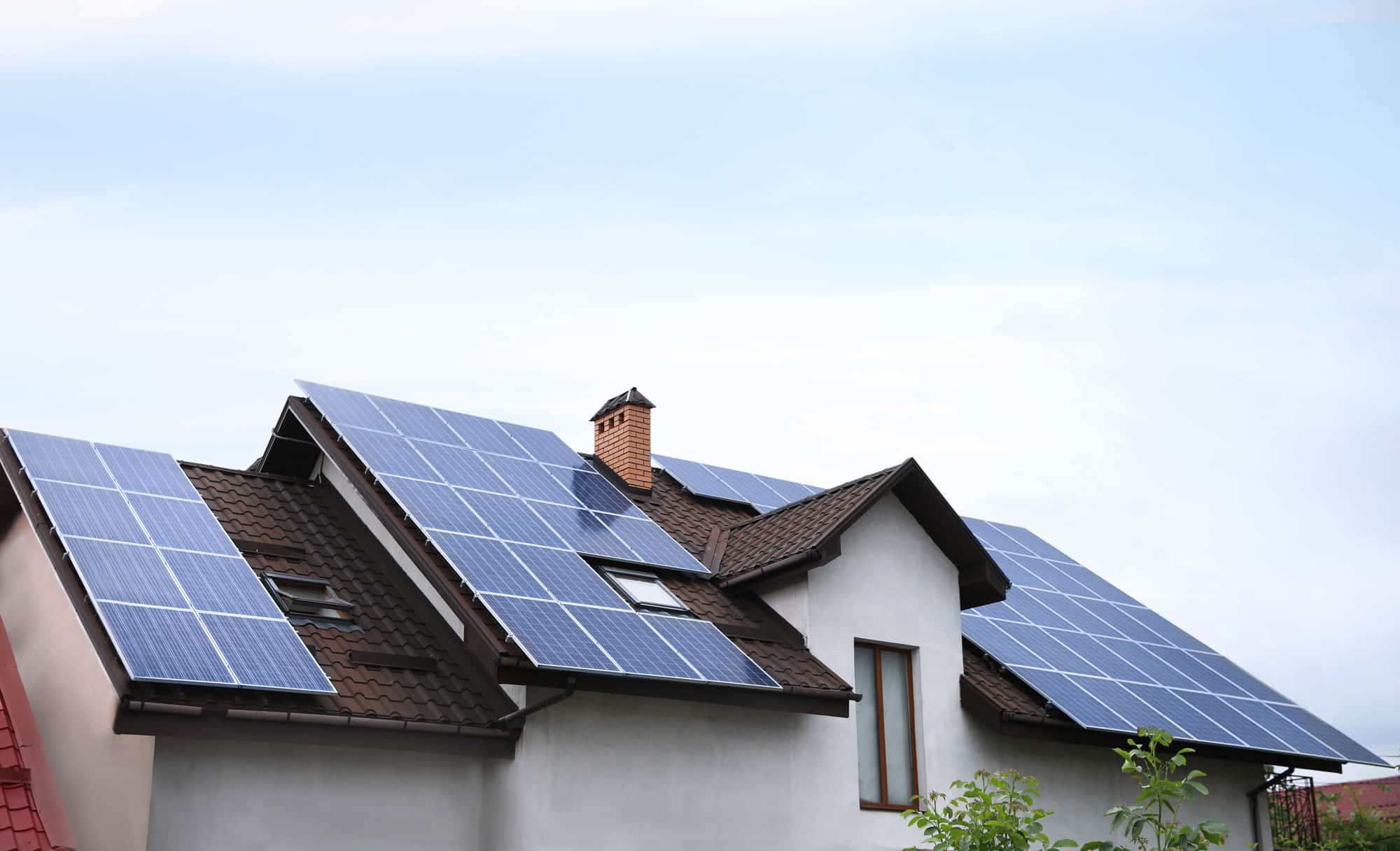 Rooftop solar panels installed on a modern home, generating clean renewable electricity from sunlight.